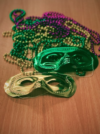 Elegant masquerade masks resting on a navy blue and champagne decorated table.