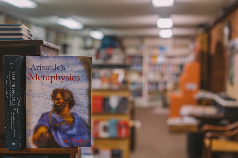 selective focus photography of Aristotle's Metaphysics book