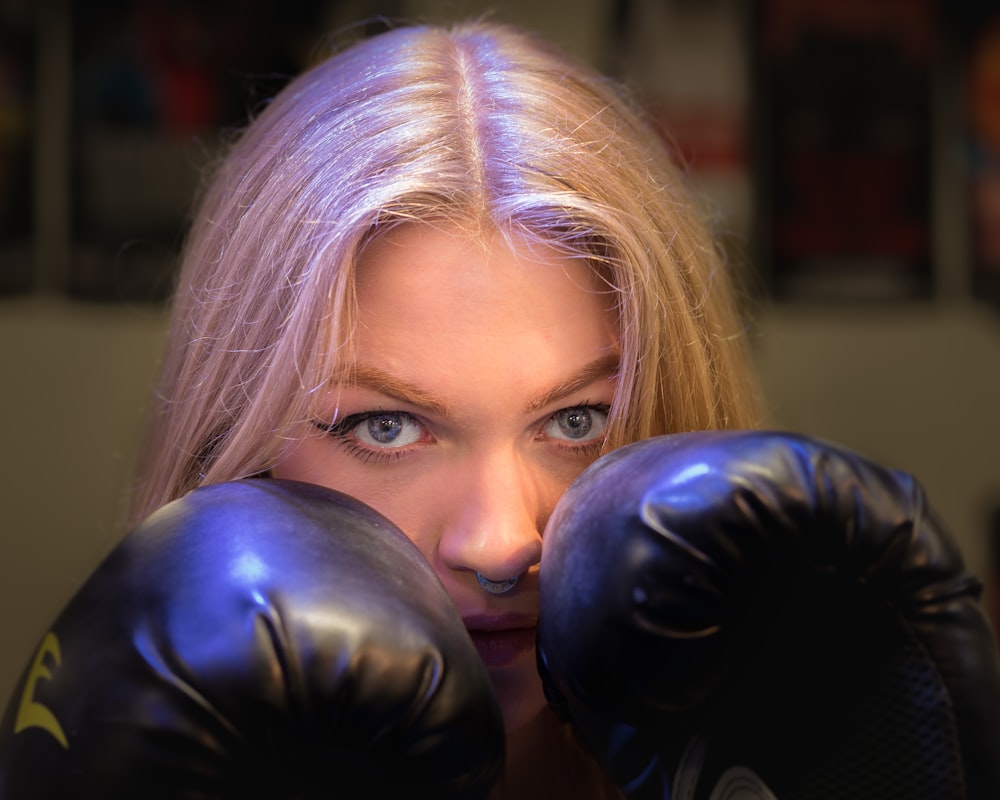 woman wearing black leather boxing gloves