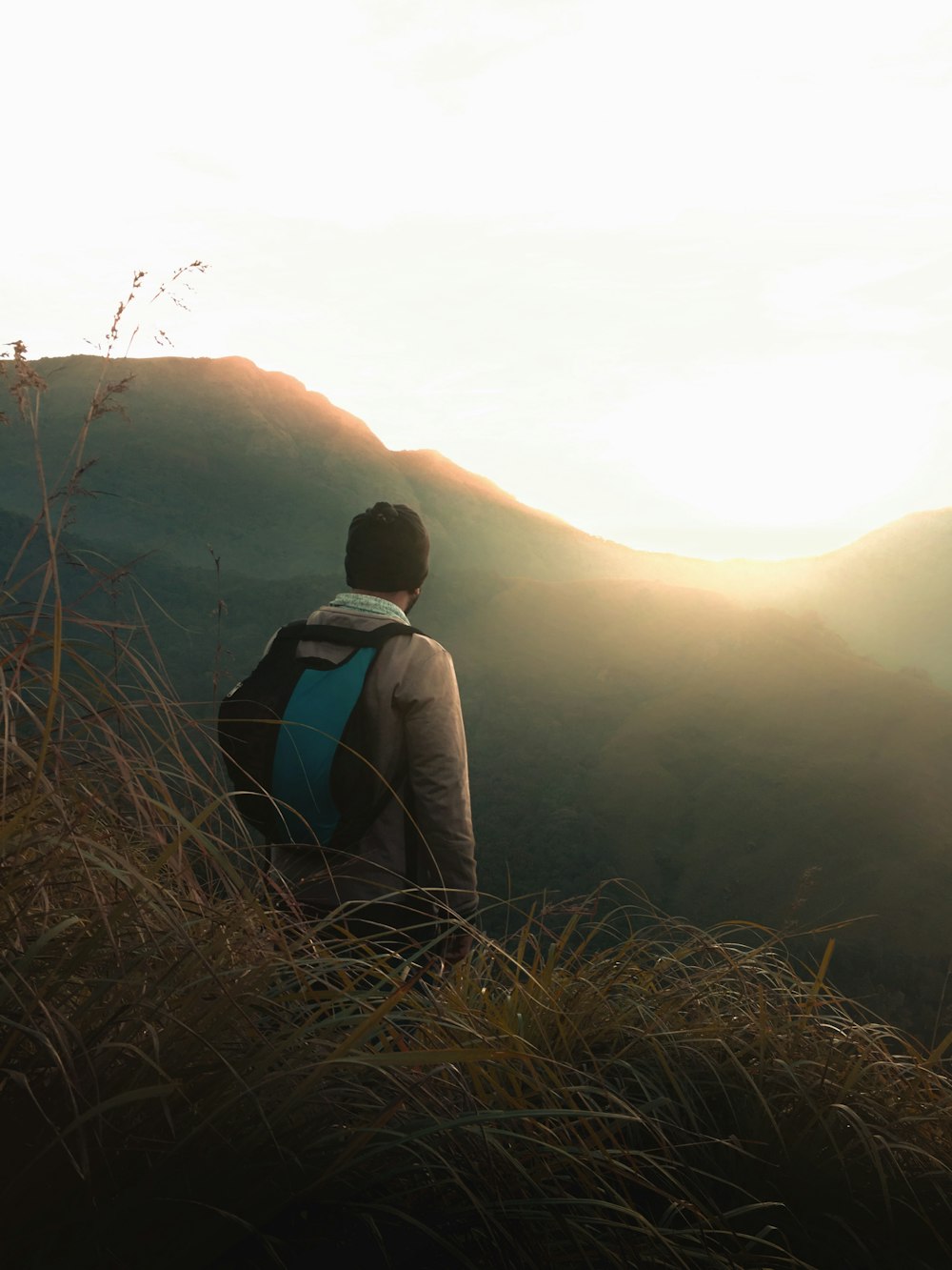 man standing on top of mountain during daytime