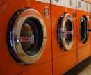 three red front-load clothes dryers