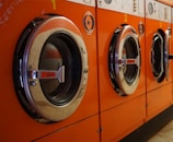 three red front-load clothes dryers