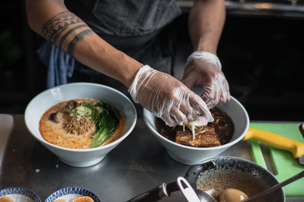 person using plastic gloves making food