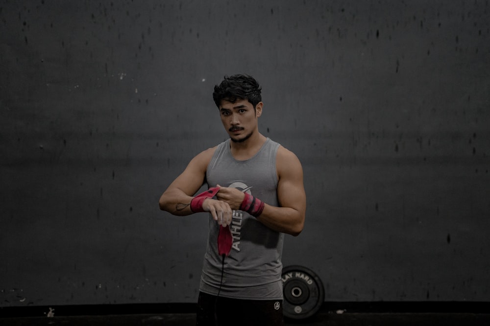 man standing wearing gray tank top