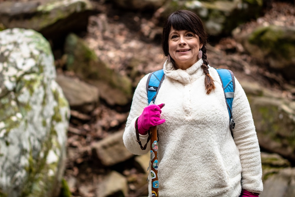 woman wearing white sweater while smiling