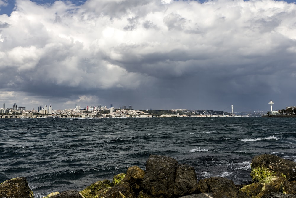 city and sea under white clouds