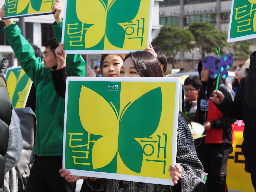 people holding butterfly signs