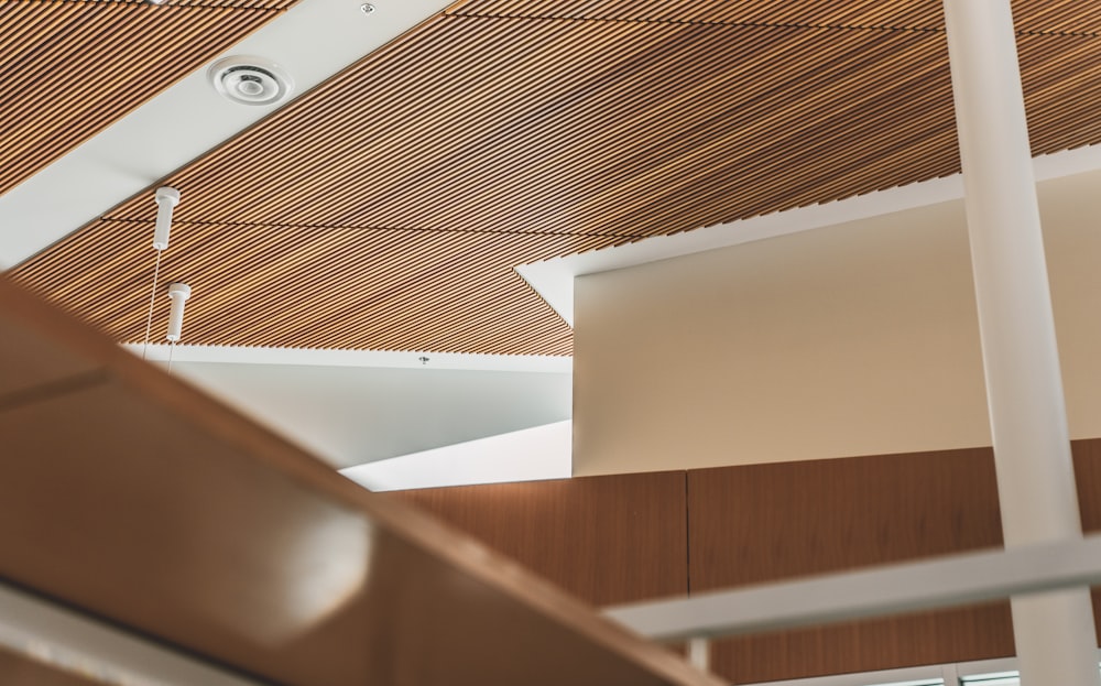 the ceiling of a building with wooden panels