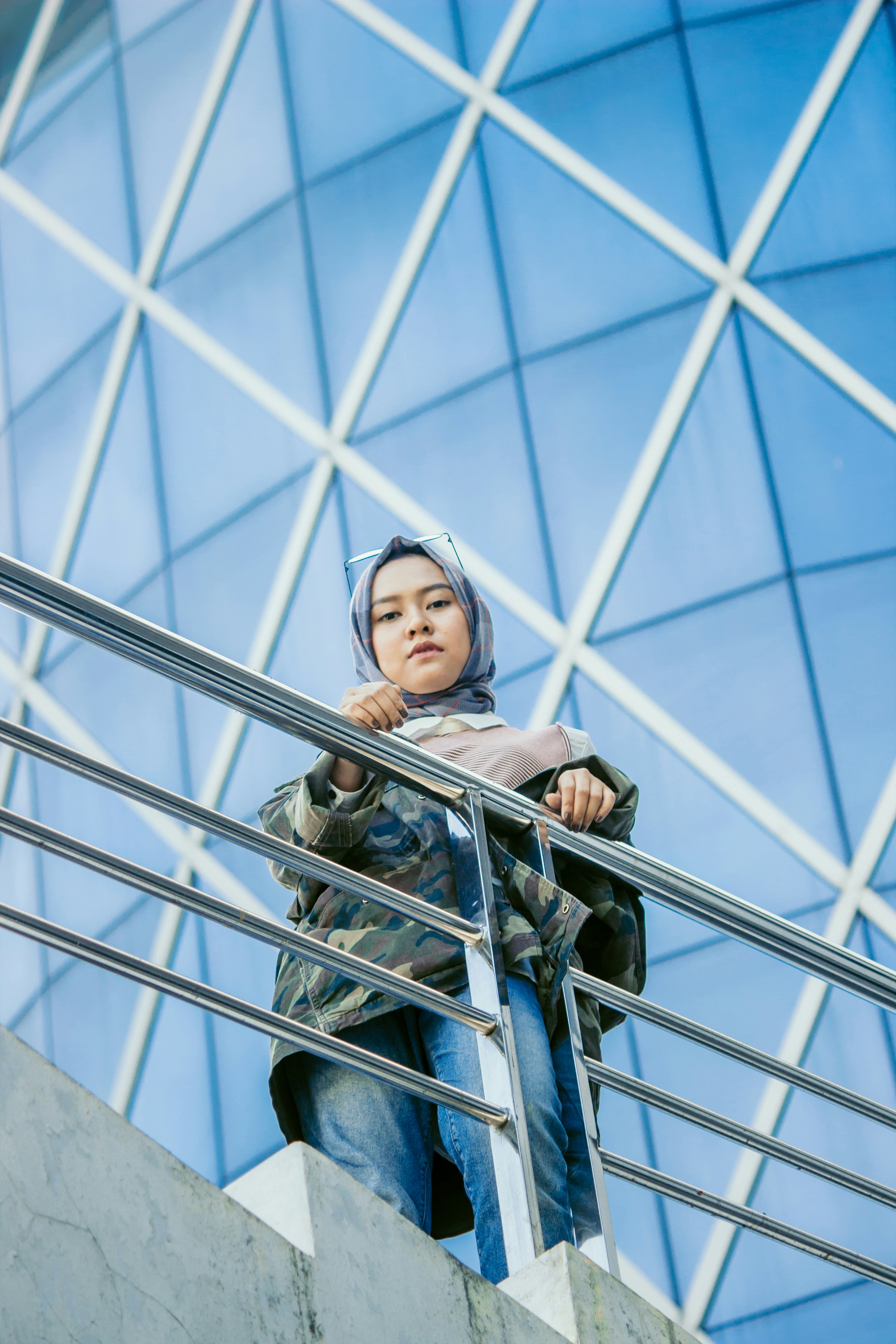 woman standing beside railings of building