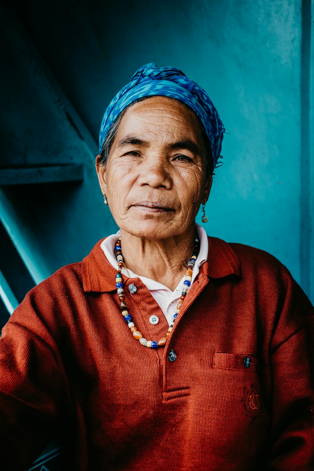 woman wearing blue cap and red top