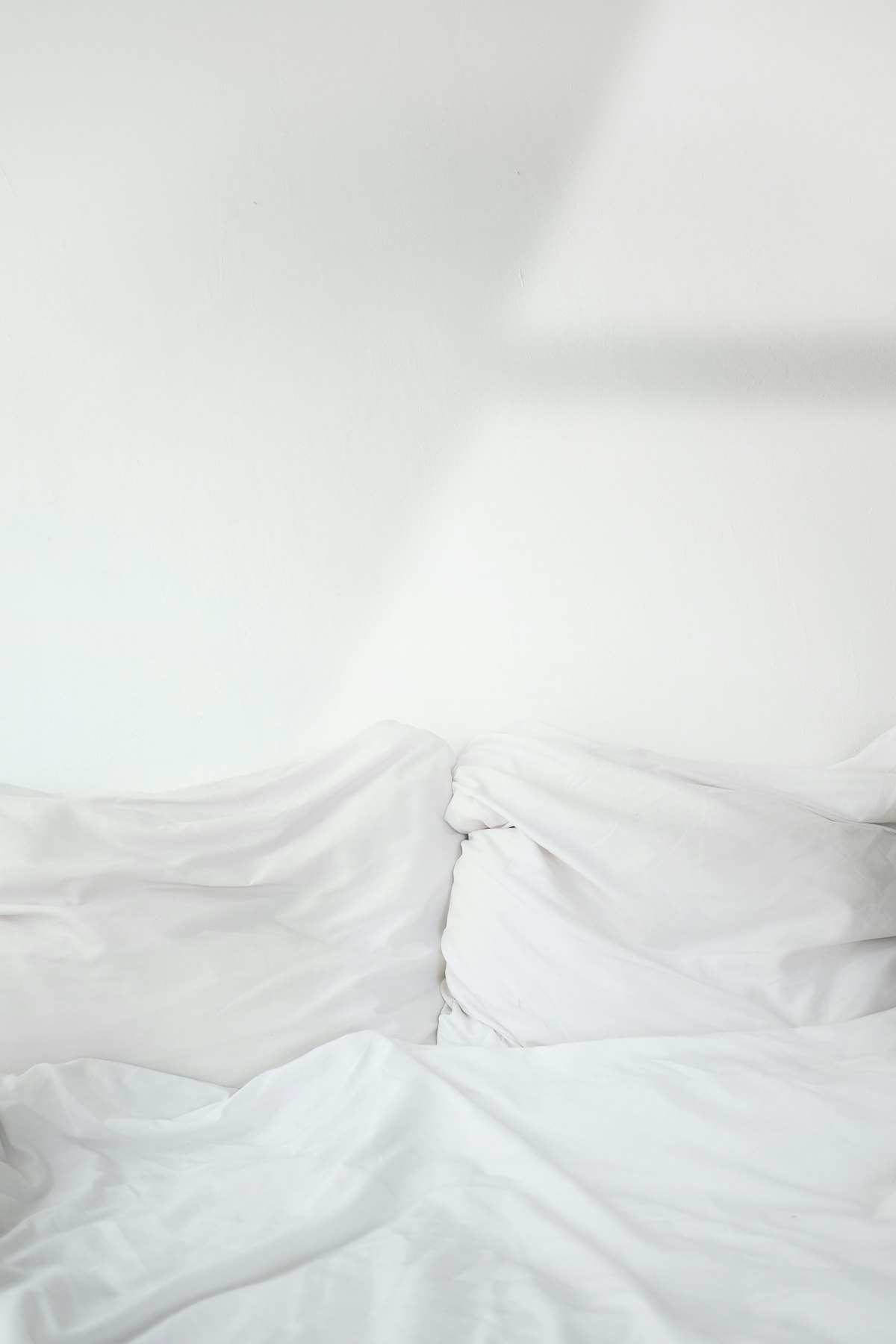 Hotel housekeeping staff preparing room with fresh linens