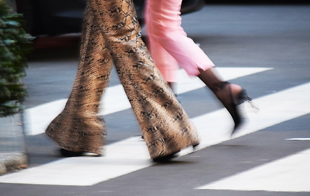 person wearing brown and black floral pants