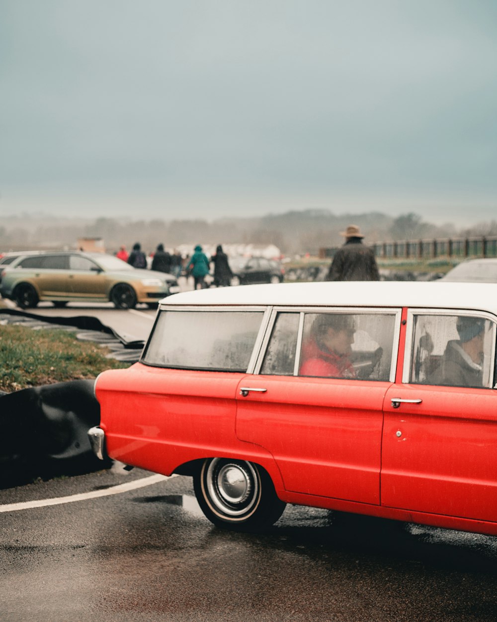 people inside red station wagon