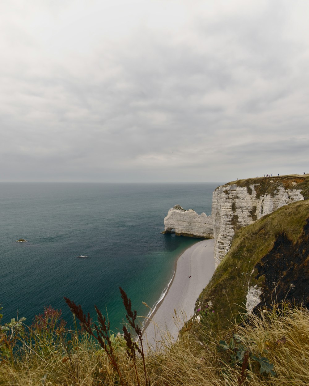 calm body of water near cliff