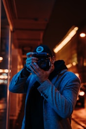 man taking photo using DSLR camera