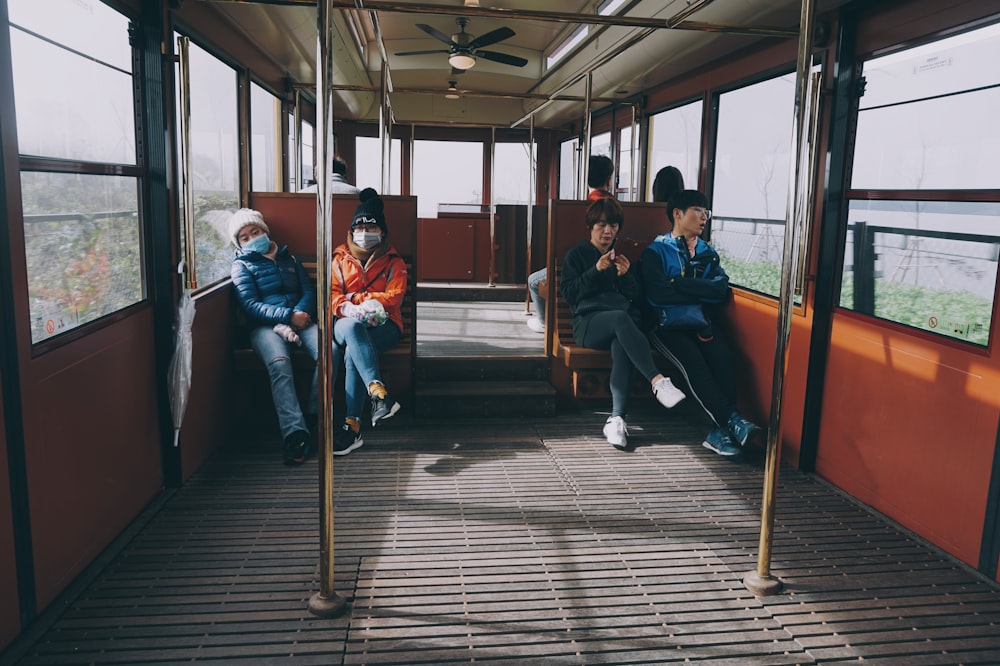 four person sitting on train