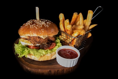hamburger beside fries and ketchup- Rasa Veda Hotel Shikohabad