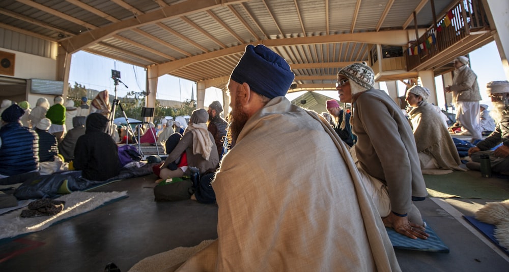 people sitting on mat during daytime