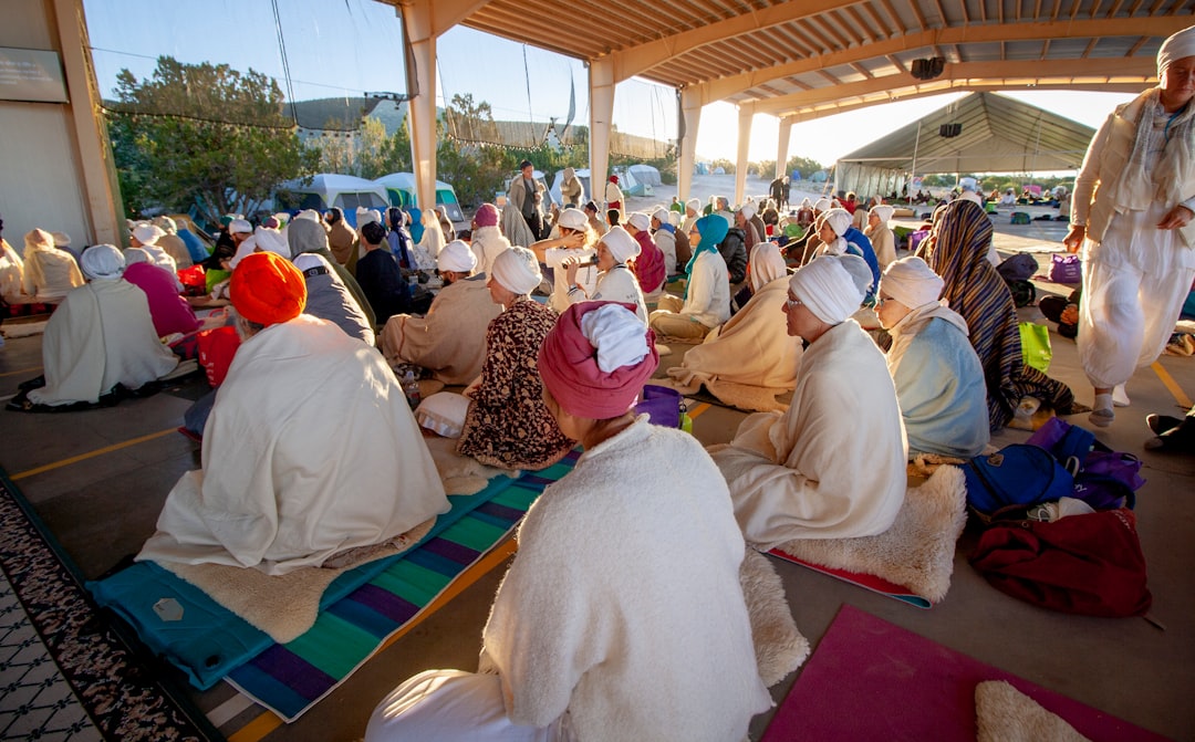 people sitting on floor while praying photo