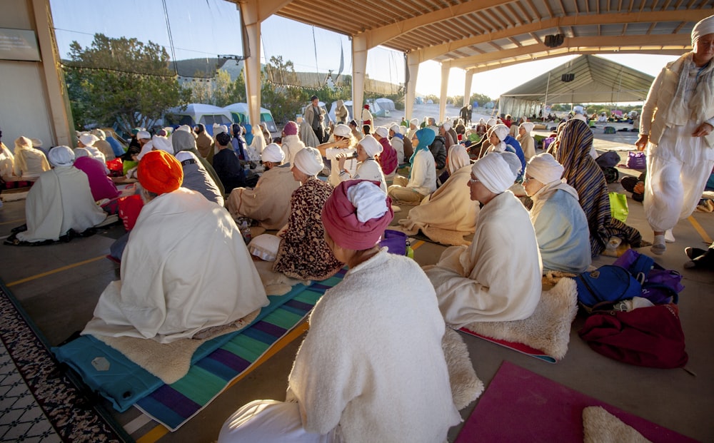 people sitting on floor while praying photo