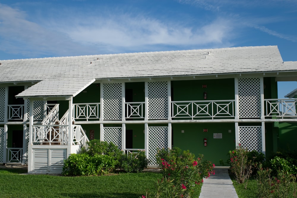 white and green concrete house during daytime