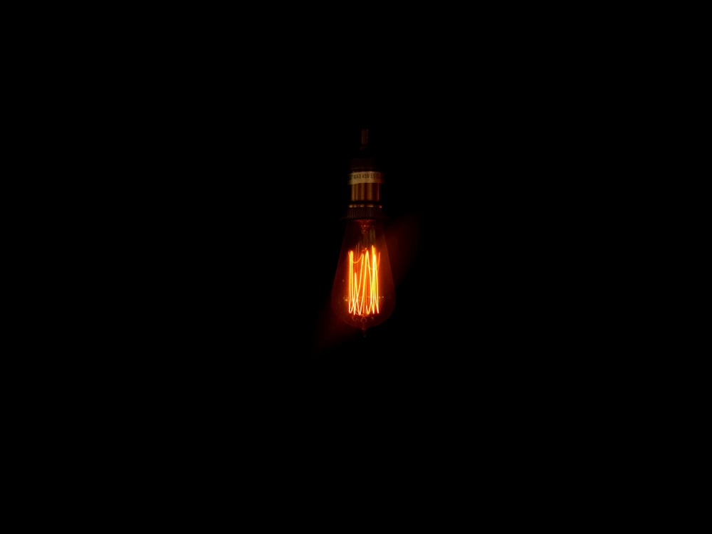 turned-on yellow incandescent bulb