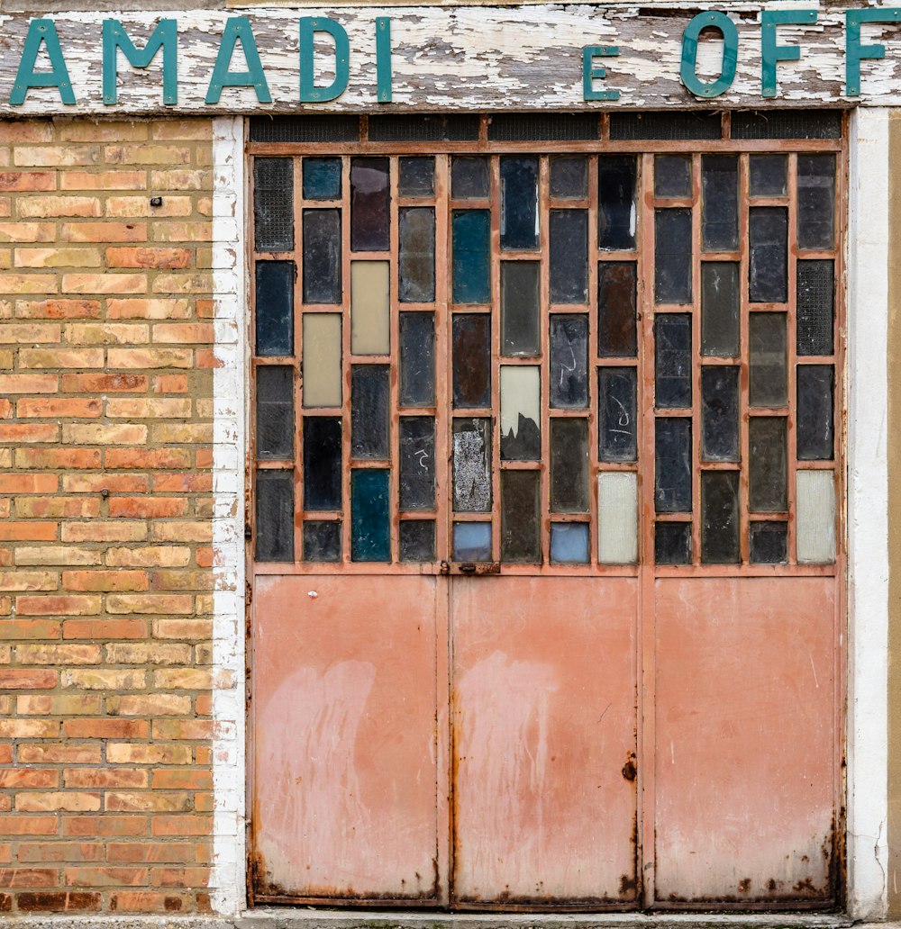 a brick building with a closed door and a sign that says amadi e -