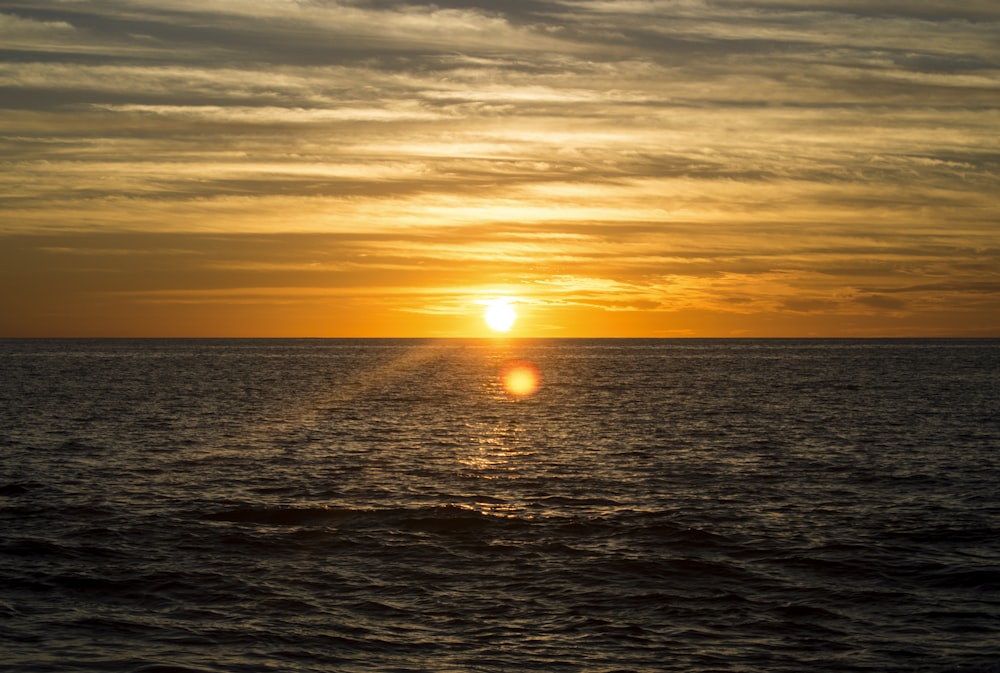 body of water during golden hour