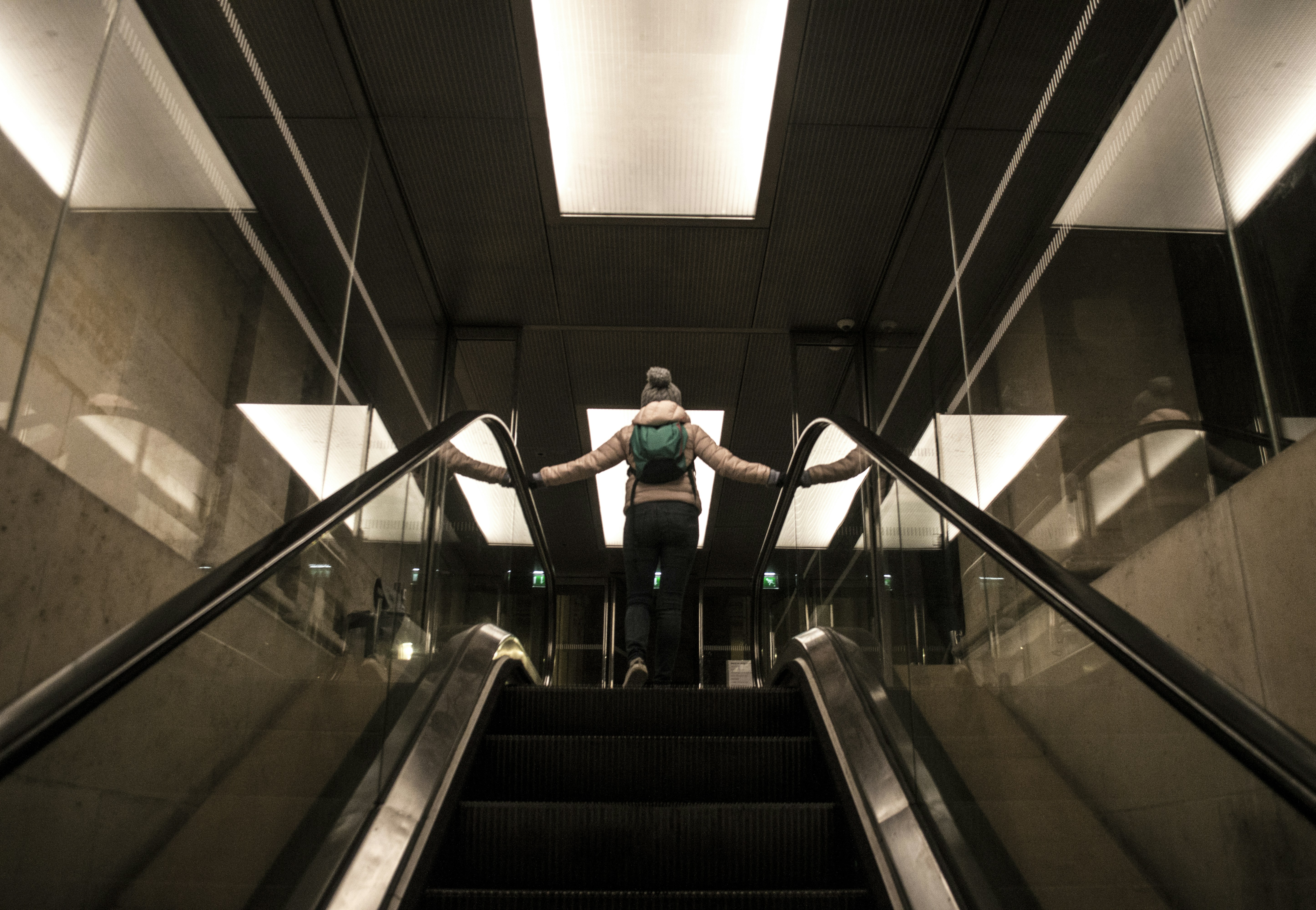 woman standing on escalator