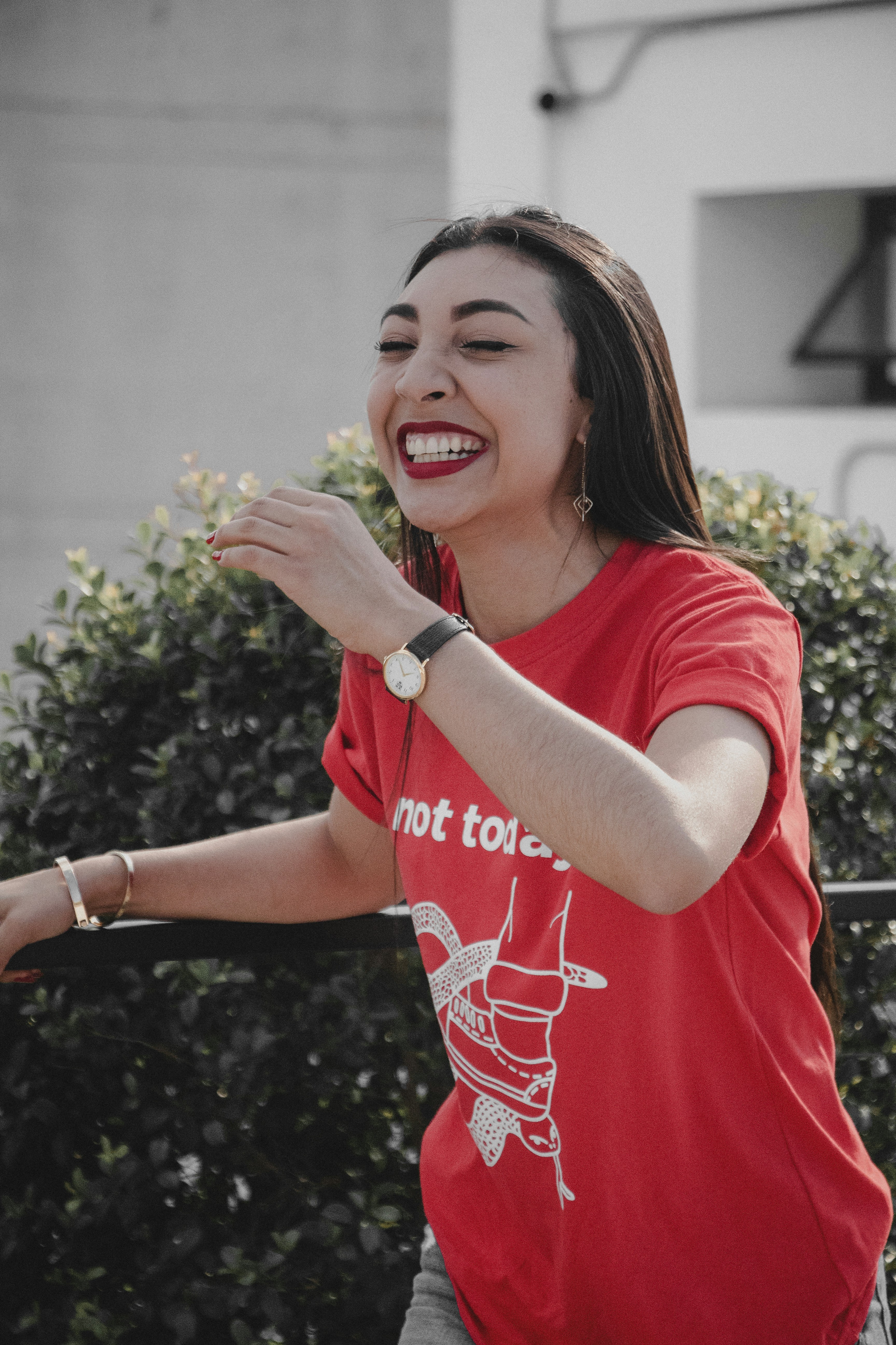 smiling woman wearing red and white shirt