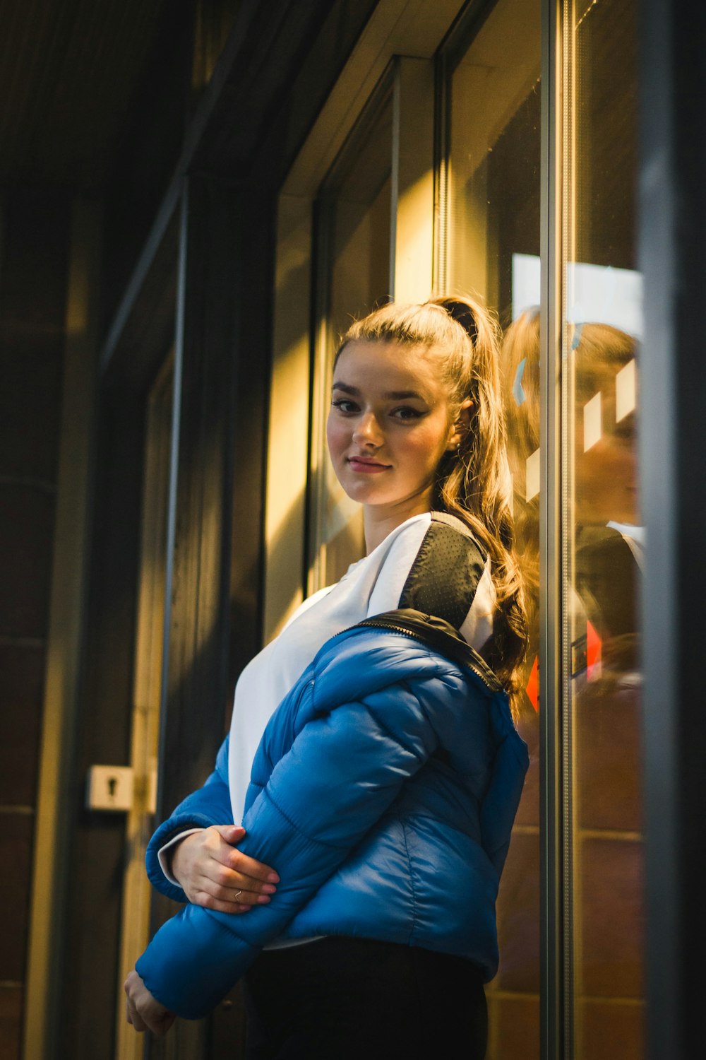 woman leaning on glass wall