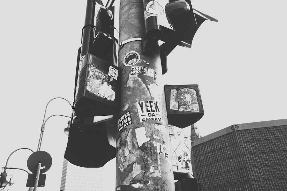 a pole with a bunch of stickers on it