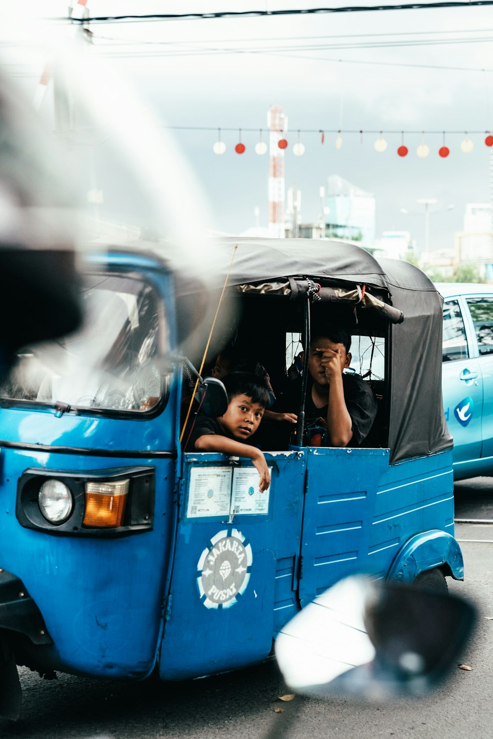 people riding autorickshaw during day