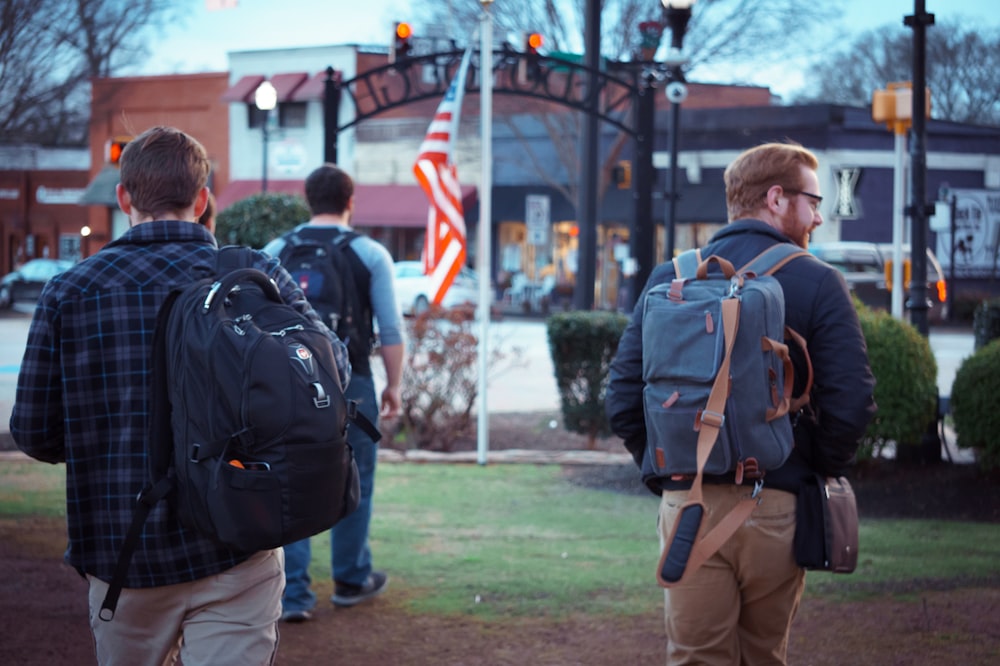 men walking towards flag on pole