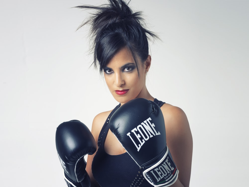 woman wearing black Leone leather boxing gloves