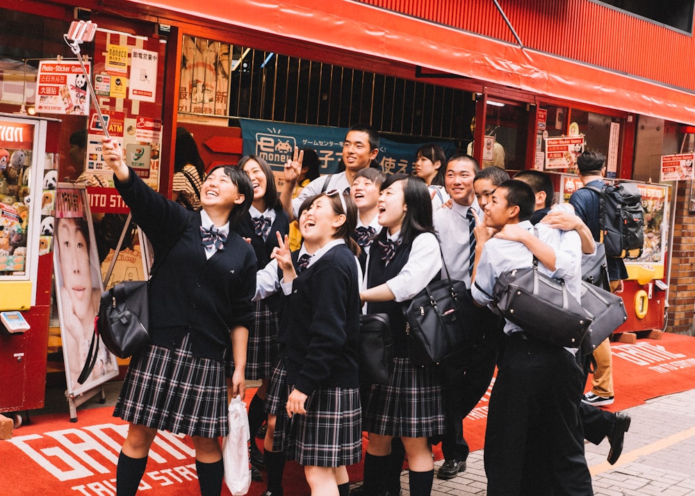 students taking groupie photo during daytime