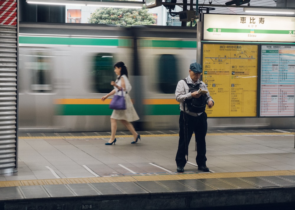 man standing at train station