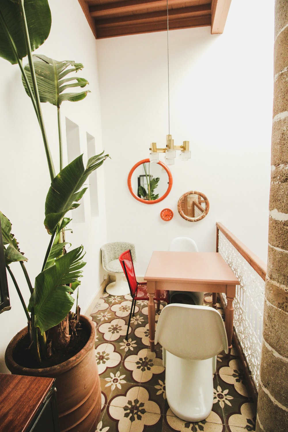 vacant white chain near table and green plant on brown pot