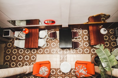 two orange sofa chairs inside room eclectic zoom background