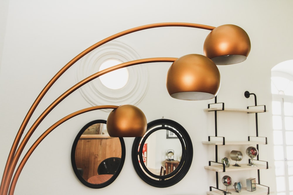brass-colored 3-light floor lamp inside room