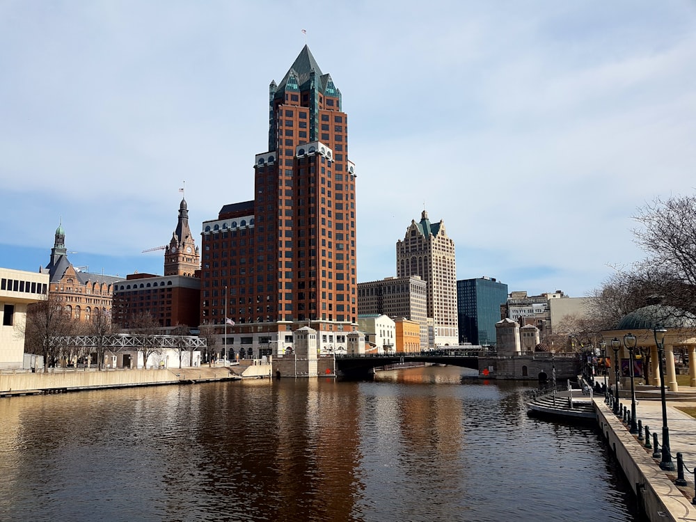 brown high-rise building near body of water