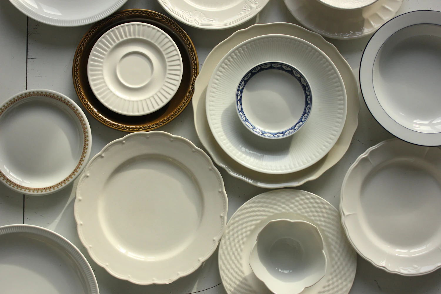 Elegant white and patterned china plates arranged on a table