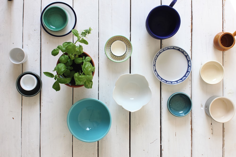 assorted-color ceramic bowl on white wooden surface