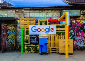 google logo beside building near painted walls at daytime
