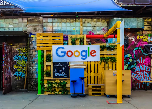 google logo beside building near painted walls at daytime