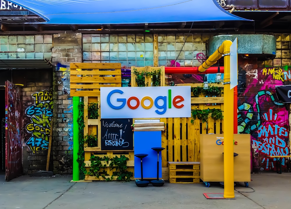 낮에 페인트 칠한 벽 근처의 건물 옆에 있는 Google 로고