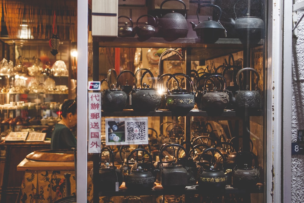 black teapots on shelf inside building