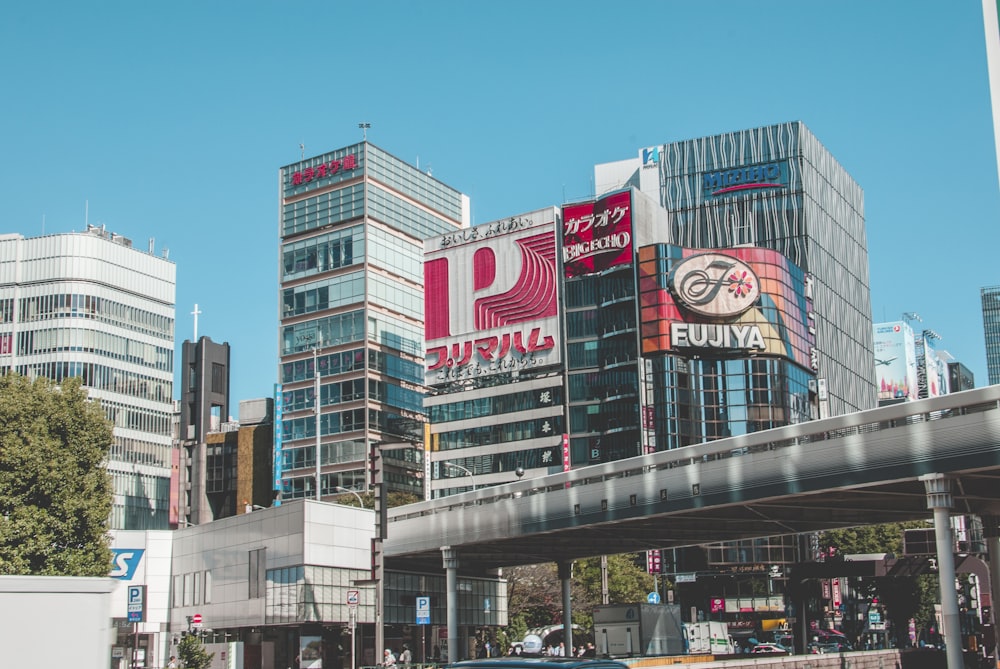 high rise buildings near overpass