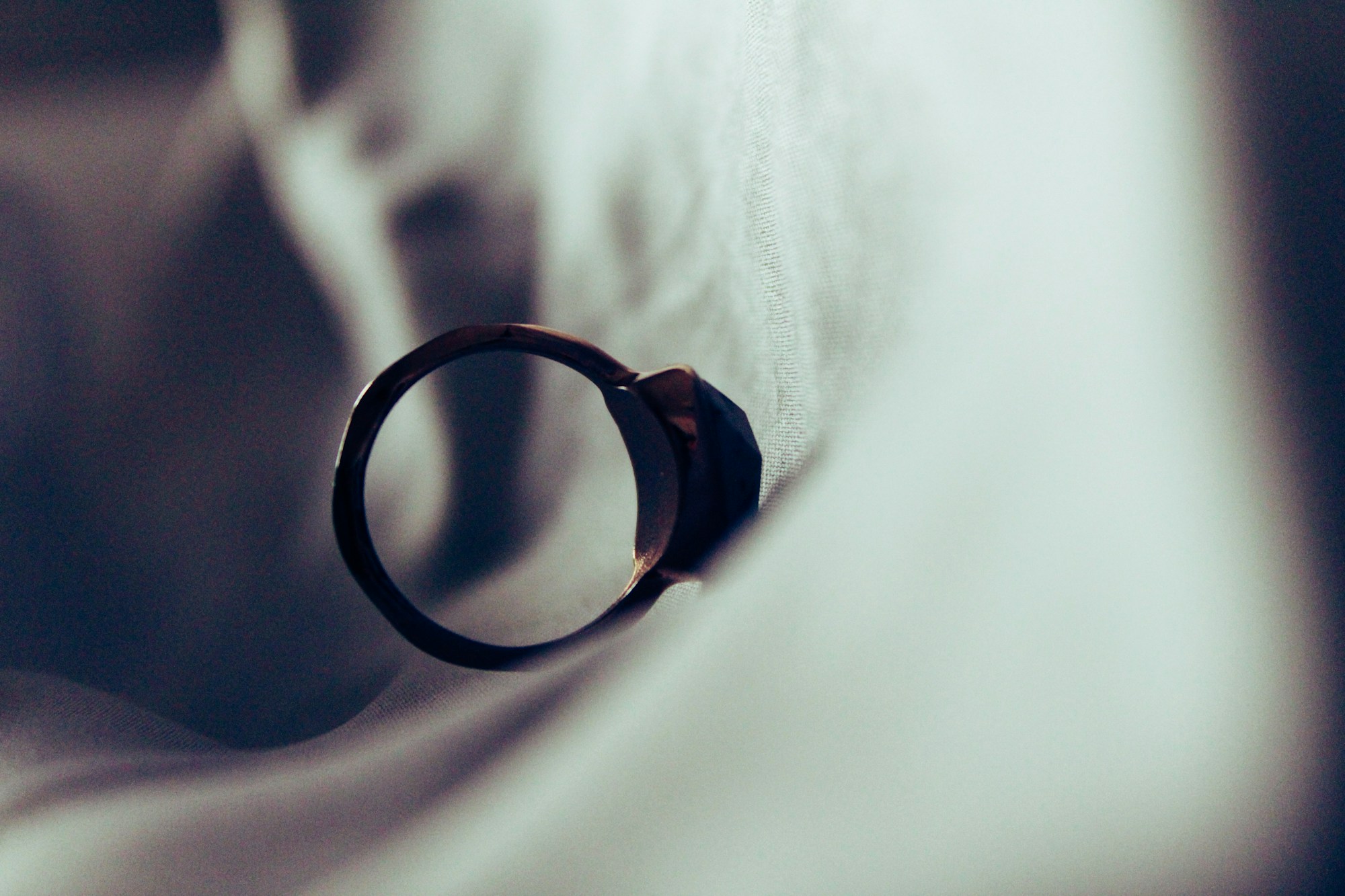 Gold wedding ring resting on a surface