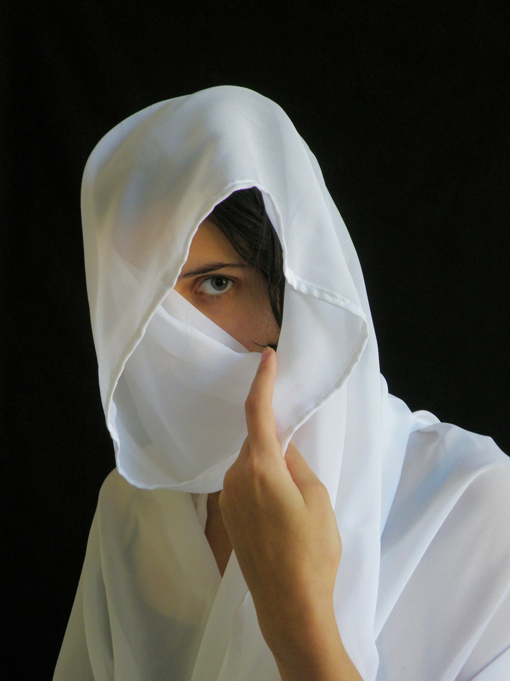 woman wearing white headscarf covering her face